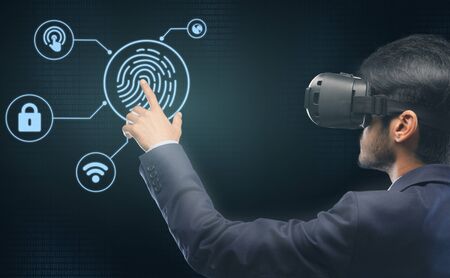 Biometric Authorization Access. Businessman In VR Headset Touching Virtual Panel With Finger For...