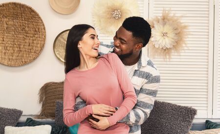 Love concept. African american husband and european wife smiling at each otherの写真素材