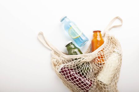 Detox diet. Blended healthy smoothie for every day drinking in glass bottles for sale in reusable mesh bag, free spaceの写真素材