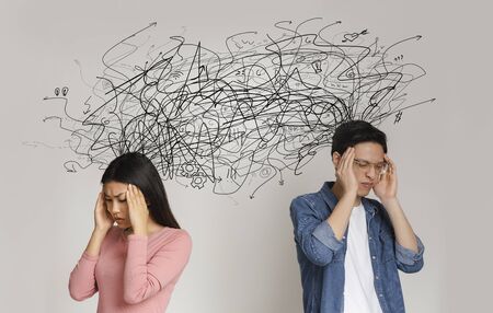 Asian young man and woman touching temples, having mess in their heads, difficult relationships concept, collageの写真素材