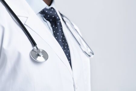 Close up of unrecognizable doctor in white robe with stethoscope on his chest, copy spaceの写真素材