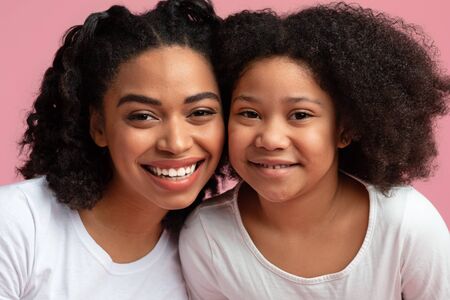 Happy Family Portrait Of Little Afro Girl Posing To Camera With Her Beautiful Mom, Embracing And...