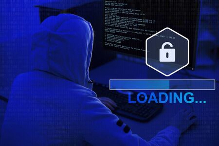 Loading information, screen with code. Hacker in sweatshirt, back