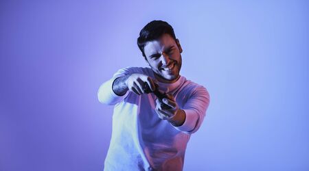 Happy guy with gamepad plays an online game, panoramaの写真素材