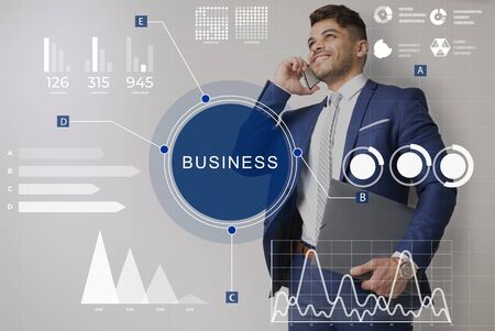 Business Statistic Information Concept. Business man talking on smart phone with holographic graphs and charts, dashboardの写真素材