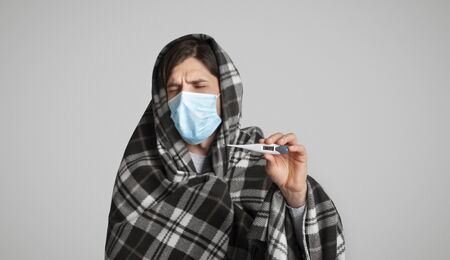 Man in protective mask on quarantine. Self isolation with high temperatureの写真素材