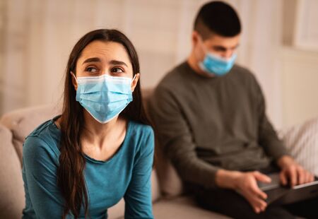 Couple Crisis During Quarantine Concept. Man using laptop, working from home, not paying attention...