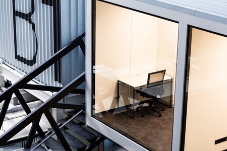 View on office room with transparent wall, open space IT corporation, loft interiorの写真素材