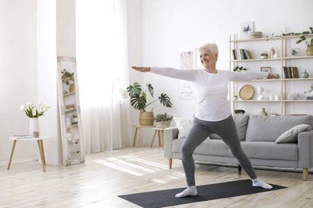 Sport On Retirement. Active Senior Woman Doing Pilates Workout At Home, Training In Living Room During Quarantineの写真素材