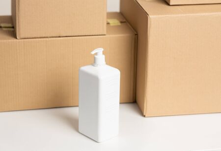 Antiseptic and cardboard boxes isolated over white background, close upの写真素材