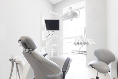 Modern dental practice. Professional chair and other accessories for doctor in room, medical lightの写真素材