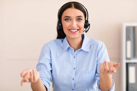 Hotline Customer Support. Cheerful Help Line Operator Girl In Headset Receiving Clients Call Smiling...