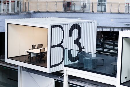 Workplaces and rest zone for workers on second floor in big open space office, no people