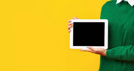 Useful Application Or Website. Unrecognizable afro teenager holding tablet with blank black screen,...