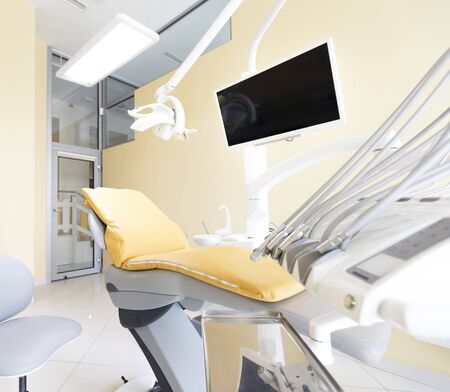 Orthodontist cabinet. View on dentist chair in modern well equipped room with TV screen, copy spaceの写真素材