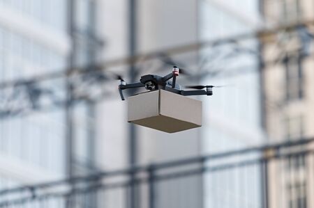 Fast and mass transportation concept, new technologies, drone transportation cardboard box, copy...