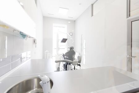 Concept of cleanliness. White dentistry room with professional equipment and tools for tooth treatment, copy spaceの写真素材