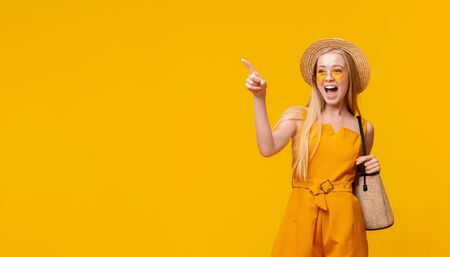 Summer Sale. Summer Portrait Of Stylish Teen Girl Pointing Aside At Copy Space On Yellow Background, Panoramaの写真素材