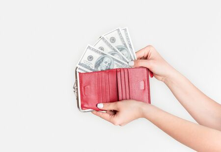 Unrecognizable young girl taking money from wallet on white background, close up