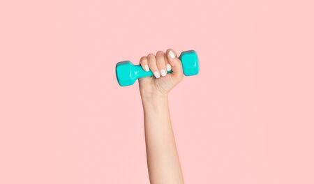 Unrecognizable female athlete with dumbbell on pink background, closeup. Panoramaの写真素材