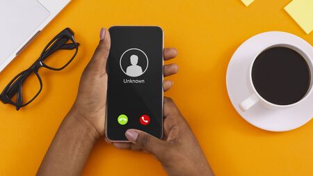 Close up Top View Of Black Female Hand Holding Phone With Incoming Call From Unknown Caller