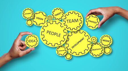 Collage of people hands holding gears with business related words on blue background, panoramaの写真素材