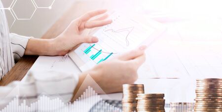 Collage with businesswoman analysing economic data on tablet screen, pile of coins and financial diagrams. Panoramaの写真素材