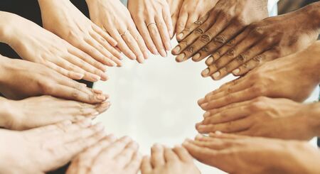 Unity Concept. Group of doctors putting hands together in clinic, high angle top view