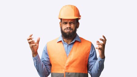 Mad Construction Worker Posing Gesturing Emotionally Wearing Helmet And Vest Over White Studio Background. Panoramaの写真素材