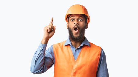Great Idea. Black Builder Worker Pointing Finger Up Having Plan Posing On White Studio Background....