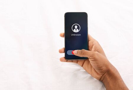 Fraud or Scam Schemes. Close up Top View Of Black Female Hand Holding Phone With Unexpected Incoming Call From Unknownの写真素材