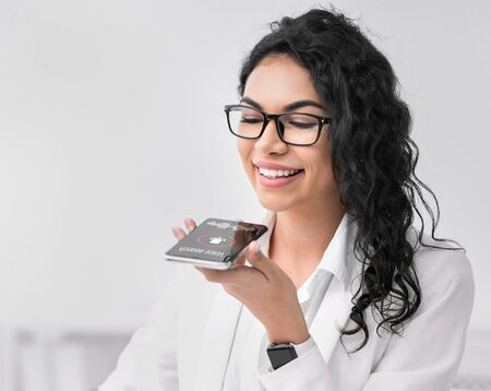Voice Search. Mexican Businesswoman Using Smartphone Personal Help Service App Browsing Internet...