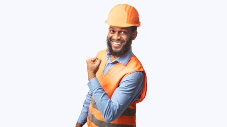 Joyful Black Construction Worker Man Gesturing Yes Smiling To Camera Standing On White Studio...