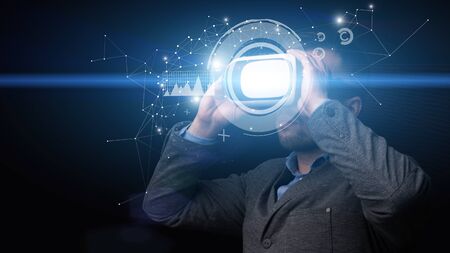 Future Technology Concept. Bearded businessman using virtual reality glasses for work, double exposureの写真素材
