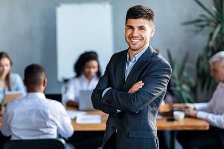 Successful Business People. Businessman At Corporate Meeting With Coworkers Smiling To Camera...