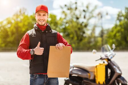 Great Courier Service. Delivery Guy Gesturing Thumbs Up Holding Paper Package Standing Near Scooter...