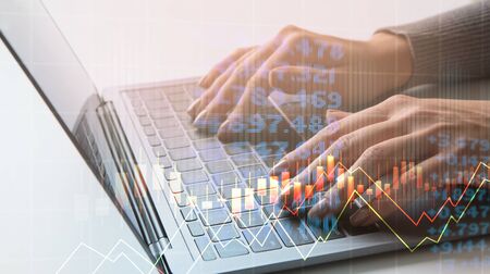 Collage with stock market data on virtual screen and businesswoman working on laptop, panoramaの写真素材