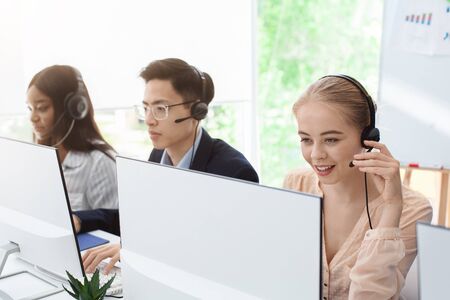 Group of millennial operators with headsets working at call centreの写真素材