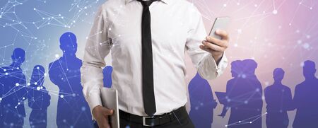 Closeup of businessman holding mobile phone and tablet computer, collage with polygonal network and people outlines. Panoramaの写真素材