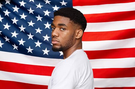 Black Lives Matter. Serious Young African American Man Posing Over USA Flag Background, Creative Collageの写真素材