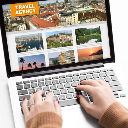 Unrecognizable Woman Using Laptop With Travel Agency Website On Screen In Office, Typing On Keybiard, Managing Vacation Bookingの写真素材
