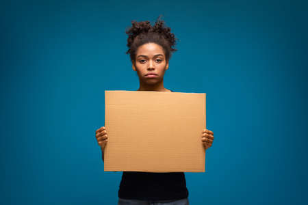 Human Rights Demonstration. African american woman standing with protest banner, empty space for...