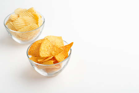 Snack to beer. Nachos and chips in glass plates isolated on white backgroundの写真素材