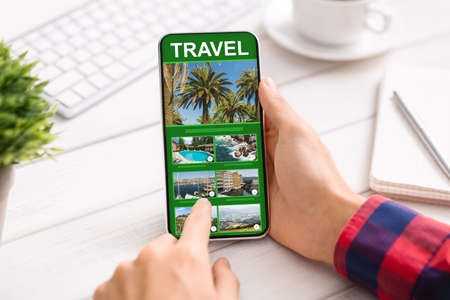 Man Using Smartphone With Online Travel App In Office, Exploring Future Destinations, Closeup To...