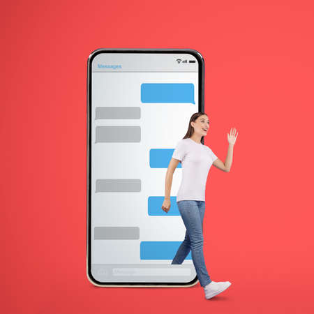 Online Communication Concept. Excited girl waving and walking out cell phone with sms chat bubbles...