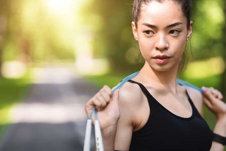 Motivated Asian Girl In Sportswear Posing With Jump Skipping Rope Outdoors, Ready For Fitness Workout, Closeupの写真素材