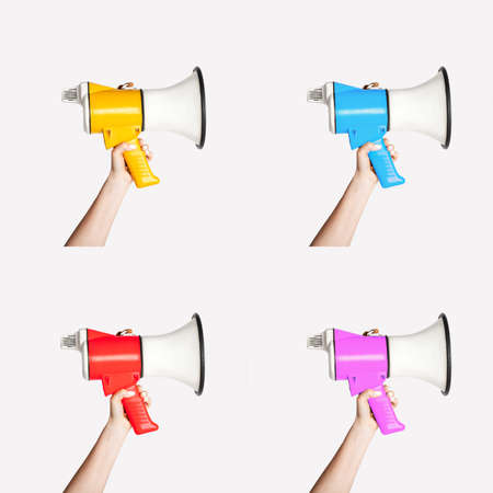 Collage with female hands holding colorful megaphones over white background, close upの写真素材