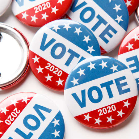 Close up of voting pins for 2020 US elections on white background, patriotic buttonsの写真素材