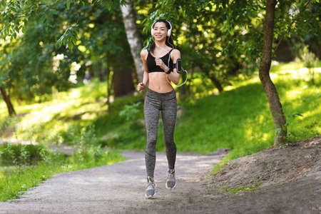 Healthy Lifestyle. Full Length Shot Of Female Athlete Running In Morning Park, Enjoying Outdoor...