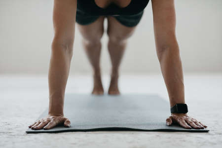 Healthy lifestyle and gym at home. Woman working out at home in living room, doing yoga or pilates...
